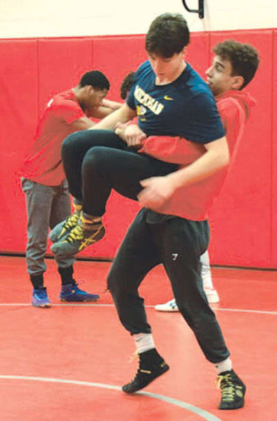  Senior captains Marcus Abdal, right, and Mattheos Mitropetros, left, work on moves during a team practice. 
