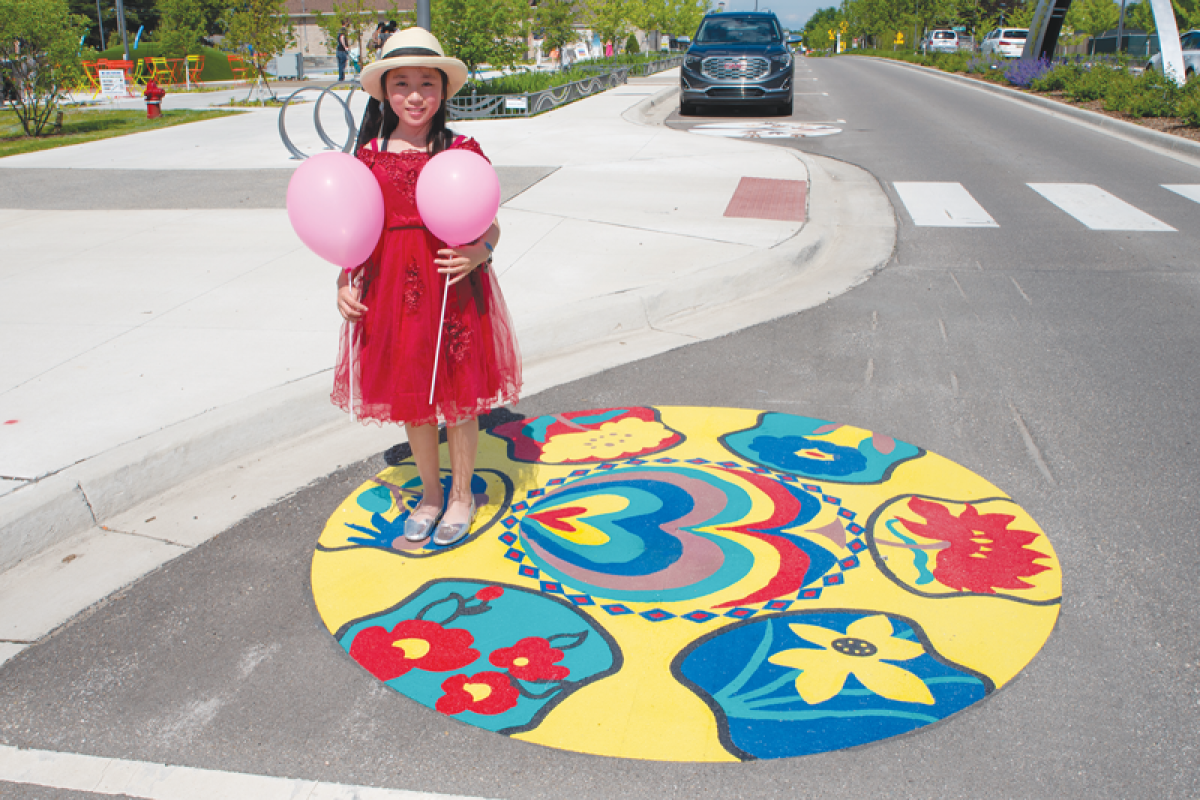  Art on Auburn 2 will bring more community art to the Auburn Road corridor. A student stands by her artwork created for the first Art on Auburn contest. 