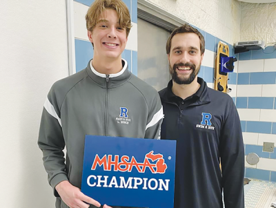  Rochester senior Lucas Hosch was superb in his final appearance at the Michigan High School Athletic Association Division 1 Swim and Dive State Championship, finishing first in the 100-yard butterfly. Pictured are Lucas Hosch, left, and Rochester swim and dive head coach Aaron Helander. 