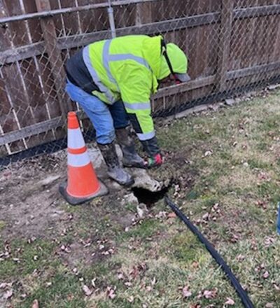  A crew member from the Macomb County Public Works Office shown repairing the sinkhole in the area of 12 Mile Road between Hoover Road and Van Dyke Avenue. 