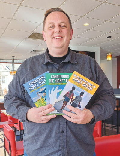  James Fabin, of Farmington, a local author who lives with chronic kidney disease, shows off the three books he has written on the subject.  