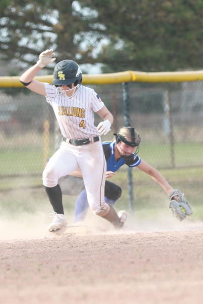  Sterling Heights senior Ella Hyatt gets onto third base safely during a matchup against Madison Heights Lamphere April 10 at Sterling Heights High School. 