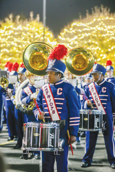  The Cousino High School marching band performs at the Twinkle Town debut Nov. 9, 2022, at Gardner White Furniture in Warren. The Warren Consolidated Schools district was recently honored with the Best Communities for Music Education designation from the National Association of Music Merchants Foundation. The Best Communities for Music Education selection is awarded to school districts that display outstanding achievement to provide music access and education to all students.  