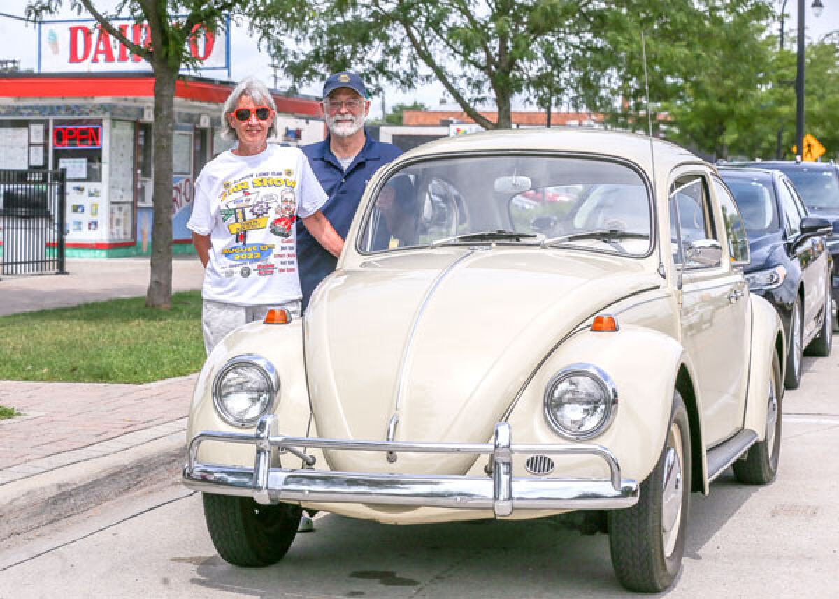  Nancy and Clive Brown, of Clawson, stand with Nancy’s 1967 Volkswagen Beetle in front of Dairy-O in Clawson Aug. 7. Clive Brown is the chair of the Down on Main Street car show. 