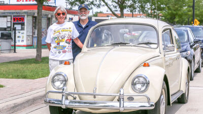  Nancy and Clive Brown, of Clawson, stand with Nancy’s 1967 Volkswagen Beetle in front of Dairy-O in Clawson Aug. 7. Clive Brown is the chair of the Down on Main Street car show. 