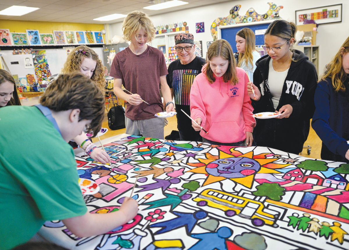  Along with eighth grade art students at Norup International School, artist Daniel Cascardo leads the students in painting one of the murals that will hang in the school. 