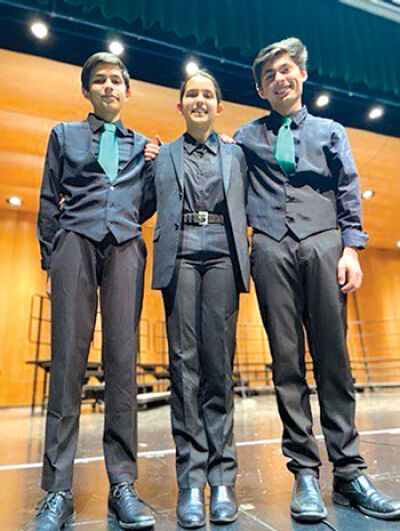  Siblings Ishaan, 15, Shivani, 12, and Milan Thurman, 17, seen here after a choir concert last fall, will all have roles in Novi High School’s production of “Singin’ in the Rain,” with the two brothers taking on lead roles, and their sister working behind the scenes. 