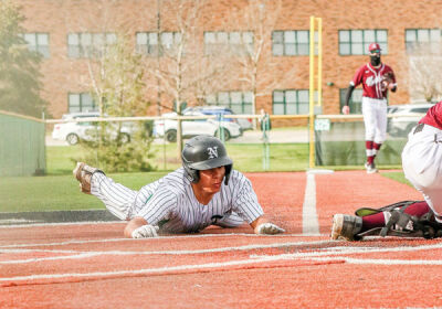  Novi junior Michael Mohtadi slides into home to score a run for Novi in a matchup against Walled Lake Northern on April 5 at Novi High School. 