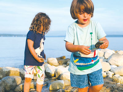  Teddy Ehrlich shows off the rock he’s found while his twin sister Arlie Ehrich searches for more rocks. 