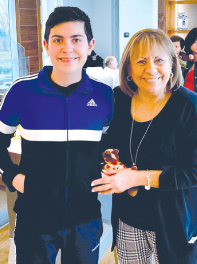  Gabriel Taverner, 14, of Novi, takes a photo with his hero, his grandmother Benita Puzzuoli, of Canton. 