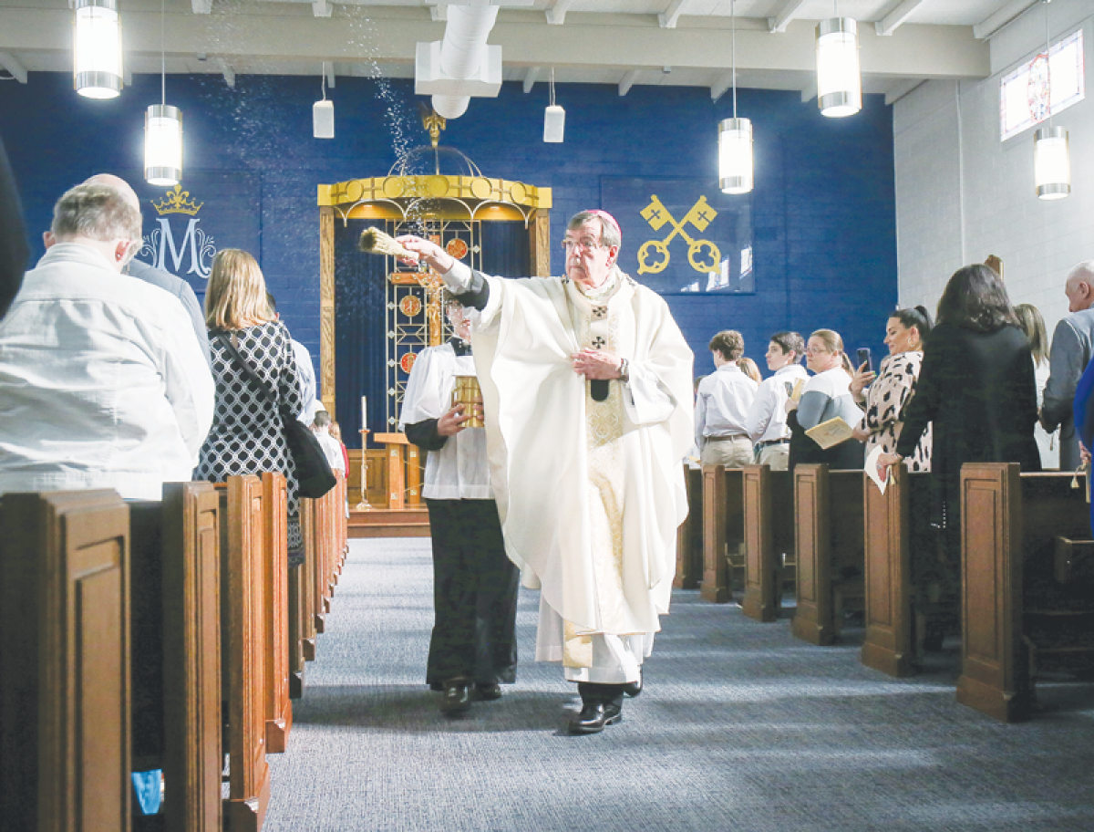  Archbishop Allen Vigneron of the Archdiocese of Detroit sprinkles parishioners with holy water at the dedication Mass of the new chapel at St. Mary’s Catholic School in Mount Clemens on April 16.  