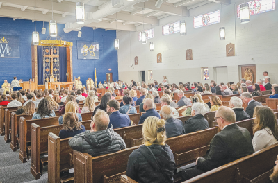  Students, faculty and other parishioners attend the first Mass at the Our Lady of the Annunciation Chapel, located at St. Mary’s Catholic School in Mount Clemens. The repurposed gymnasium will host two  services a week for students. 