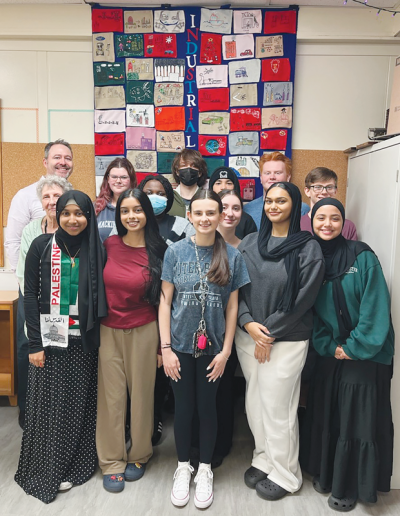  The Advanced Placement world history students in Jaime Bellos’ classroom at Center Line High School, as well as two other classes, studied the Industrial Revolution by making a quilt together. Teacher Jaime Bellos is pictured at the top left, and paraprofessional Paulette Nantais is standing in front of him. 