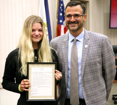  Sophia Vitale stands with Macomb Township Supervisor Frank Viviano after being recognized for performing CPR. 