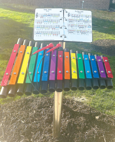  A rainbow-colored xylophone comes with a music book as part of Sterling Heights’ outdoor musical instrument setup, which is located by its public library. 