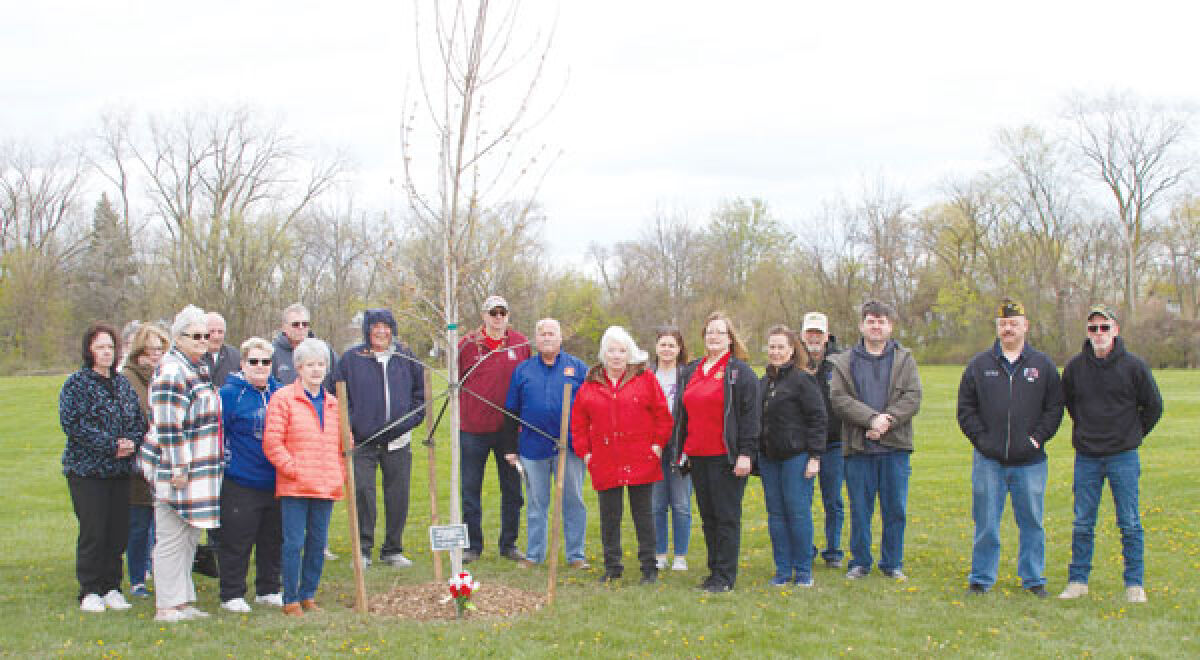  Attendees at the April 20 tree dedication for veterans who died from suicide pose for a photo. 