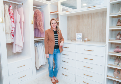  Kelly Osten, of Closet Connections, stands in the closet she designed with Aubrey Crawford and Ashlynn Robinson for the show house. 