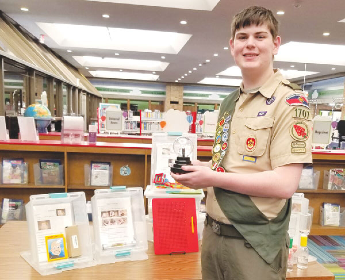  Isaac Bucknell shows off some of the STEM kits he created as a part of his Eagle Scout project for the Troy Public Library. 