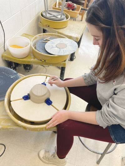 Novi High School senior Dagny Gulledge utilizes a new trimming bat for her ceramics project. 