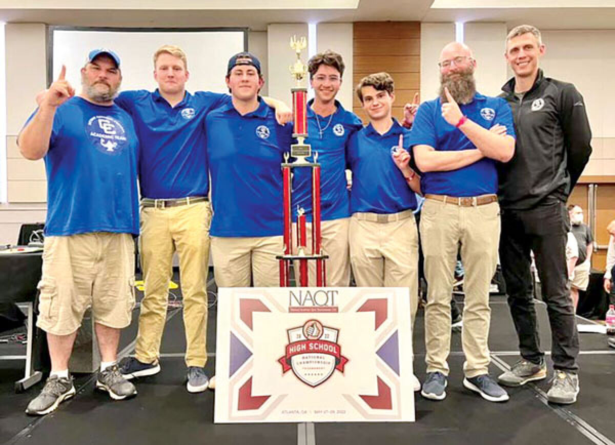  Co-head coach Benjamin Herman, Will Carstens, Liam Cross, Michael Yousif, Drew Laroo, co-head coach Christopher Gismondi and assistant coach Anthony Cornish celebrate Detroit Catholic Central’s win at the High School National Championship Tournament of quiz bowl in Atlanta last month. 