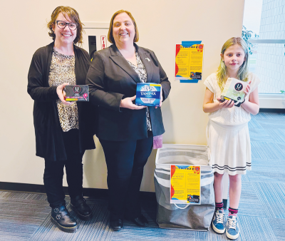  Monica Papasian, Mayor Lori Stone and Olive Papasian place a period product drive collection box in front of the mayor’s office in City Hall.  