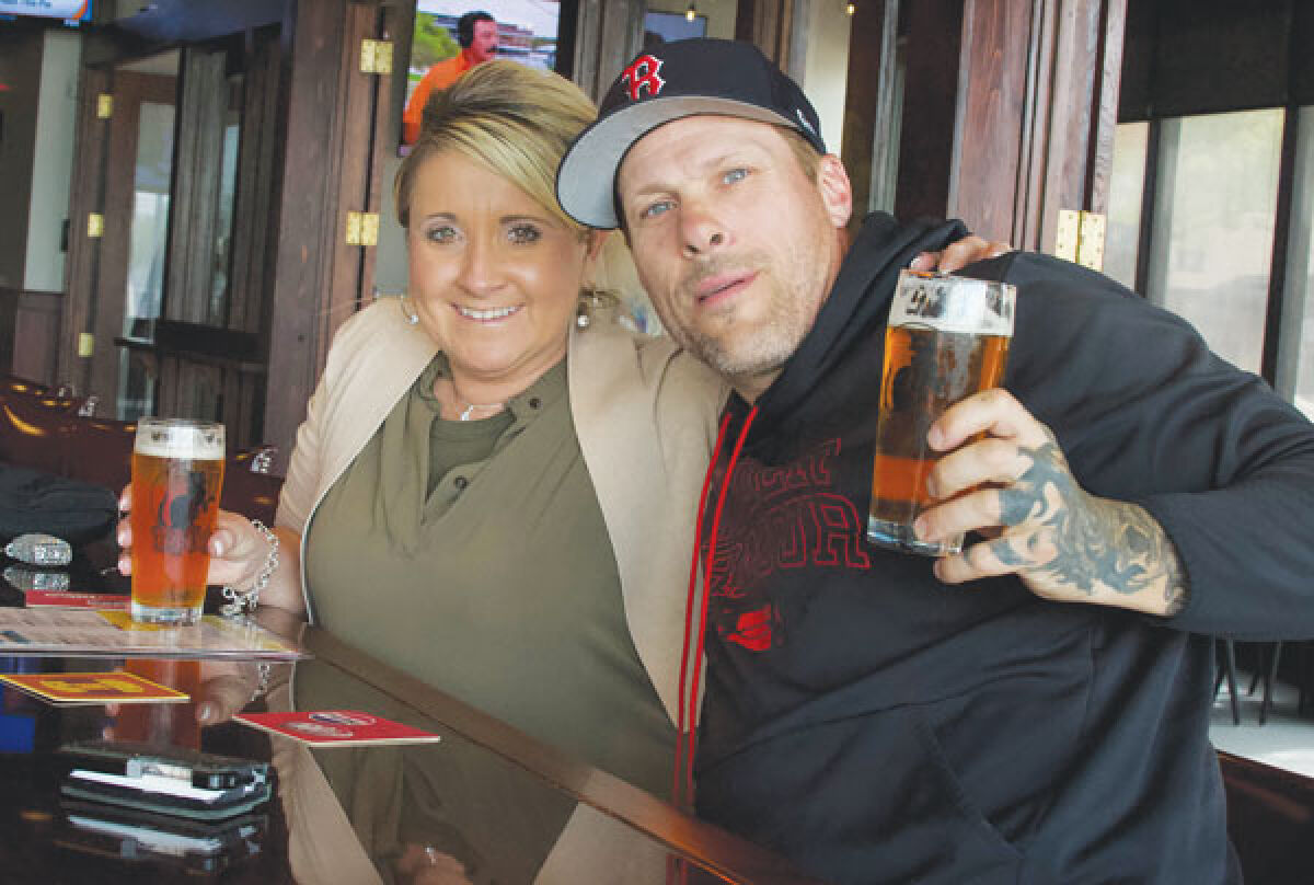  Mary Beth Hamlin, of Clinton Township, and Steve Karaffa, of Macomb Township, enjoy beers at the soft opening for HopCat’s new location on May 3 at The Mall at Partridge Creek. 