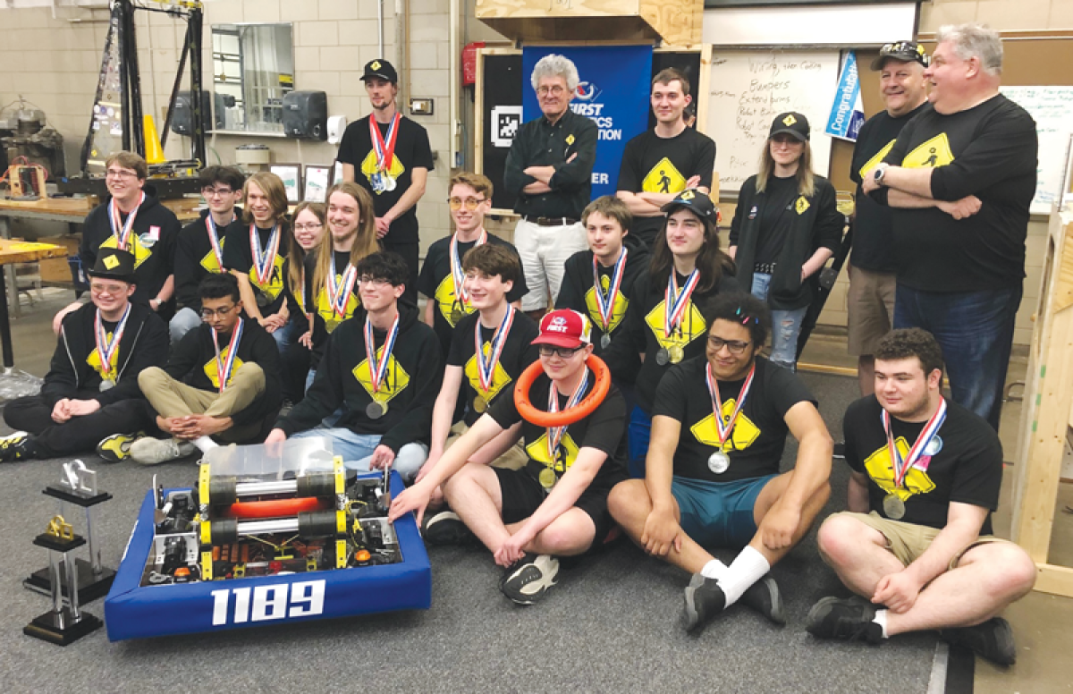  The Gearheads and their mentors gather May 2 at their workshop at Grosse Pointe North High School to receive their medals and celebrate their second-place finish at an international competition. 