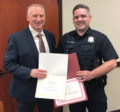  From left, Grosse Pointe City Public Safety Director John Alcorn presents officer Austin Giarmo with his Officer of the Year award and other certificates during an April 15 Grosse Pointe City Council meeting. 
