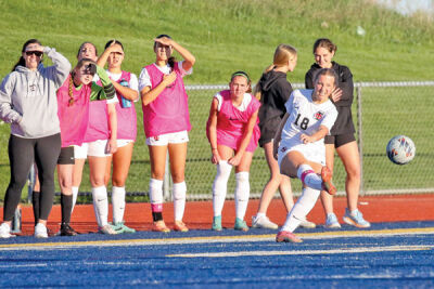  Troy senior Sydney Taylor sends a shot as the Troy bench looks on. 