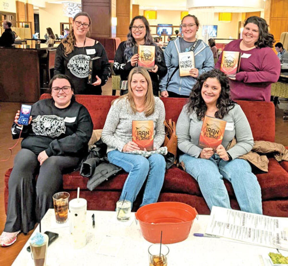  Some of the members of the Troy Silent Book Club read the same book, “Iron Flame,” by  Rebecca Yarros, during their November meeting. 