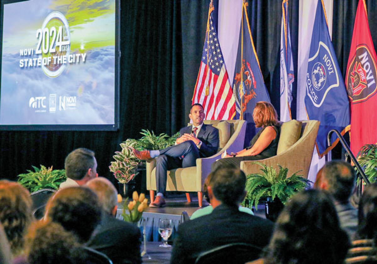  Novi Mayor Justin Fischer and Novi Director of Communications Sheryl Walsh-Molloy discuss current issues during Fischer’s first State of the City address May 1 at the Suburban Collection Showplace. 