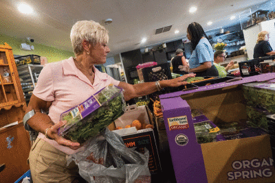  Gina Giambrone looks at items available during a food distribution at Harvest Time Christian Fellowship. 