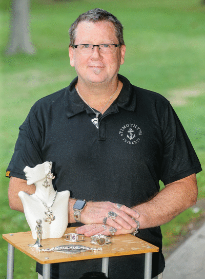  Timothy Branson, of Timothy’s Trinkets, shares samples of his jewelry work at Green Acres Park Aug. 17. He will be among the artist vendors at the Hazel Park Art Fair, which will take place at the same park Aug. 27-28. 