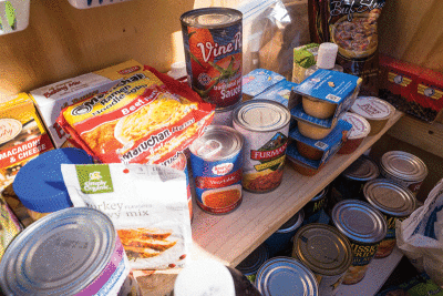  Various food items fill the “blessings box”  food pantry in the front yard of Soucy’s home. 