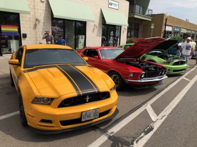  Ford Mustangs park on both sides of Nine Mile Road for the city of Ferndale’s annual Mustang Alley at the Woodward Dream Cruise. 