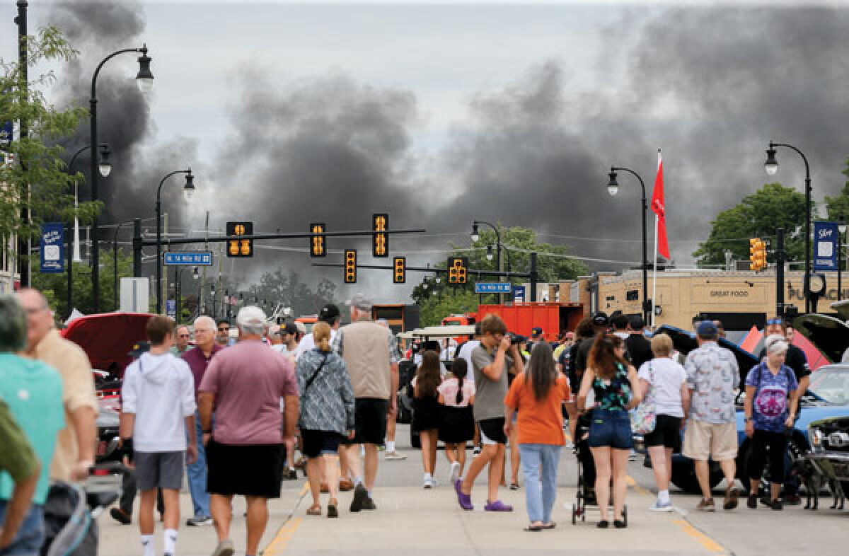  Black smoke from a transformer fire behind the post office rises above the Clawson Lions Club’s 24th annual Down on Main Street Car Show Aug. 13. 
