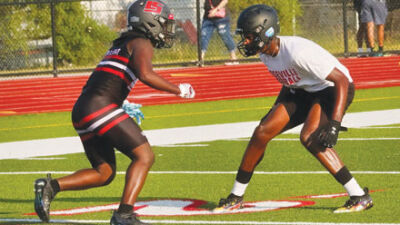  A St. Clair Shores Lake Shore wide receiver and a Roseville cornerback face off during seven-on-seven drills. 