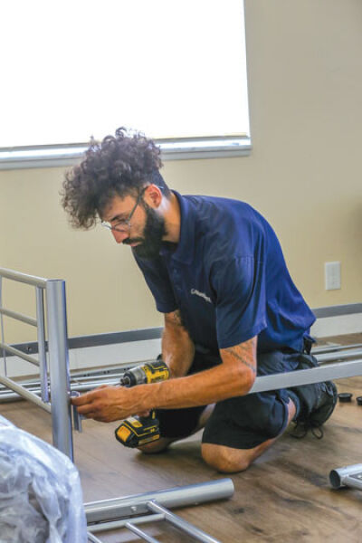  Jeff Bleske, delivery driver for Gardner-White, assembles one of the bunk beds Aug. 12. 