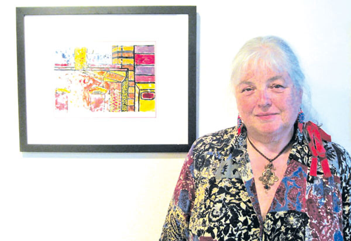  Carol Izant, seen here next to one of her art pieces, is one of two artists featured in an exhibition at Southfield City Hall until the end of September. 