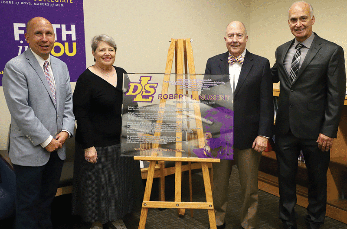  From left to right, De La Salle Alumni Relations Director and 1994 graduate Dennis Koch; Lisa Gandelot and her husband, Trowbridge Law Firm estate planning attorney Jon Gandelot, the attorney for the Nugent family; and De La Salle Advancement Director Greg Esler stand with the plaque that recognizes the $3 million gift from the Robert L. Nugent Trust.  