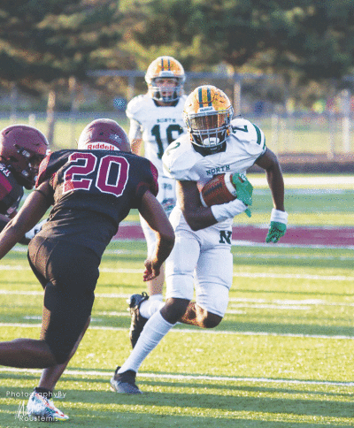  Senior running back Jaden Holyfield runs to the outside against Warren Mott. 