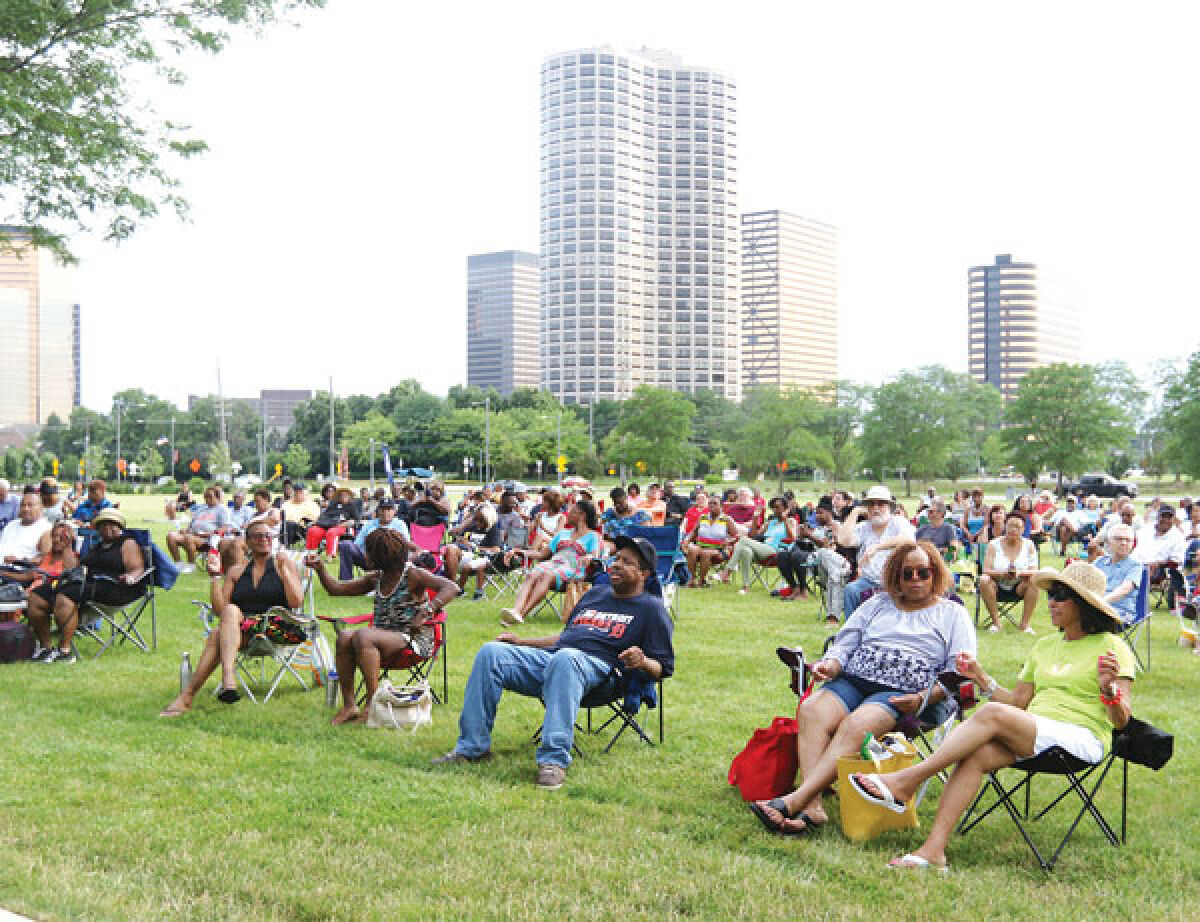 Patrons spread out across the front lawn of the Southfield Municipal Complex for a past Summer in the City concert. 
