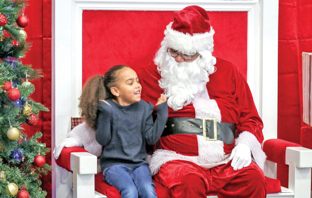  Shiloh Watson, 5, from Southfield, visits with Santa at the 2023 Soulful Santa event. 