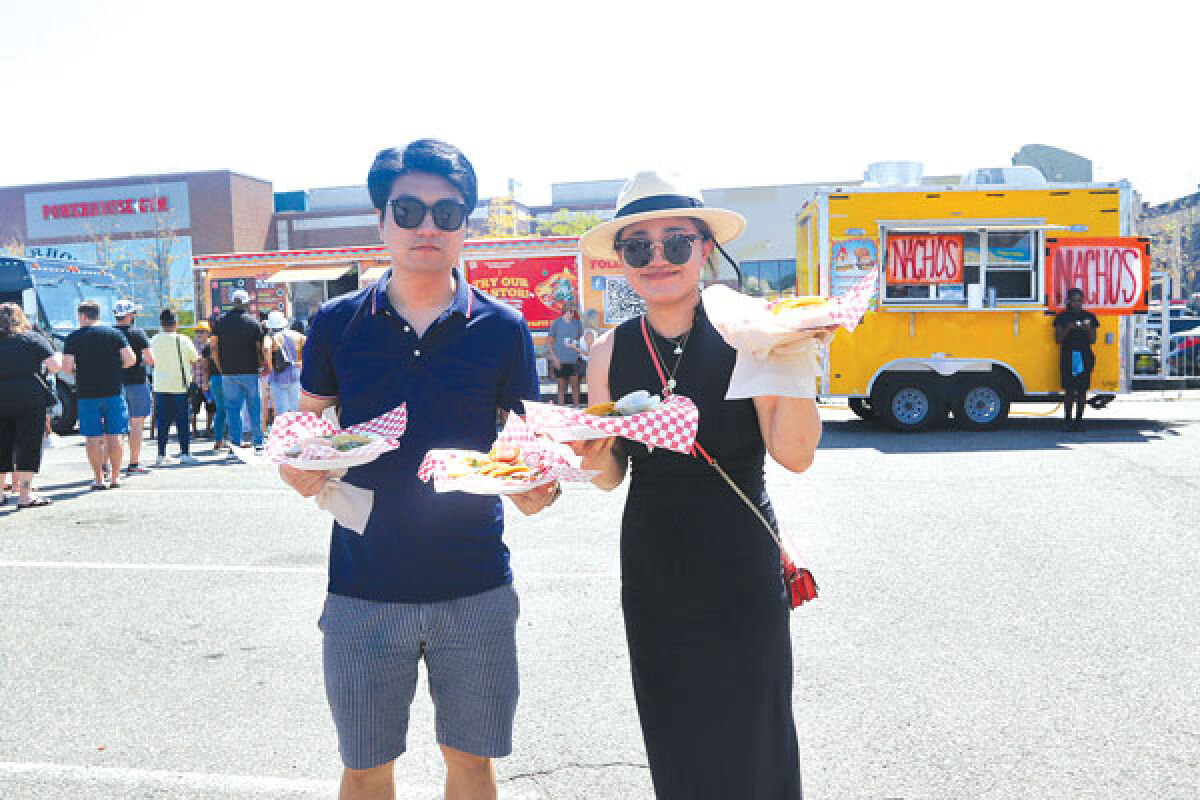  Jenny Min and Shawn Xie, both of Canton, enjoy the food selection at Novi Taco Fest, which took place Aug. 26-28 at Twelve Mile Crossing at Fountain Walk. 