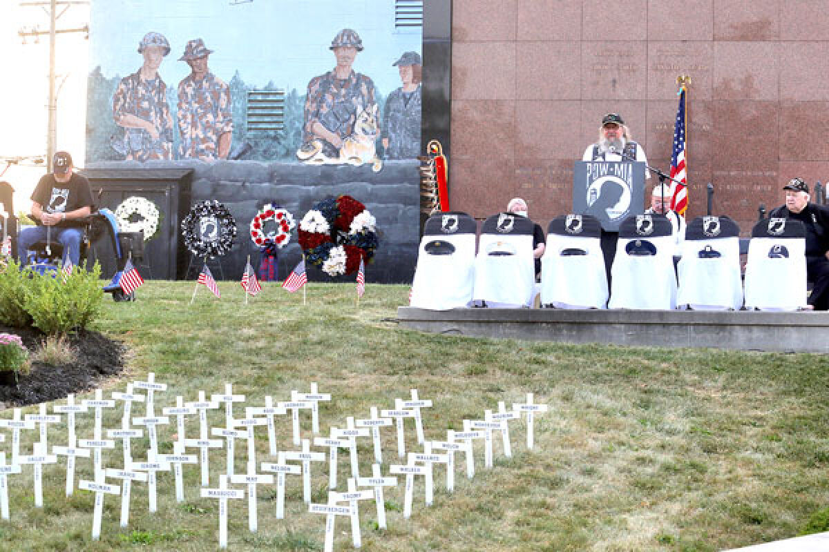  Duane O’Parka, president of Rolling Thunder, Chapter 5, speaks at the 43rd annual National POW/MIA Recognition Day ceremony held at Oakland Hills Memorial Gardens Sept. 16. The crosses represent those unaccounted for from Michigan. 