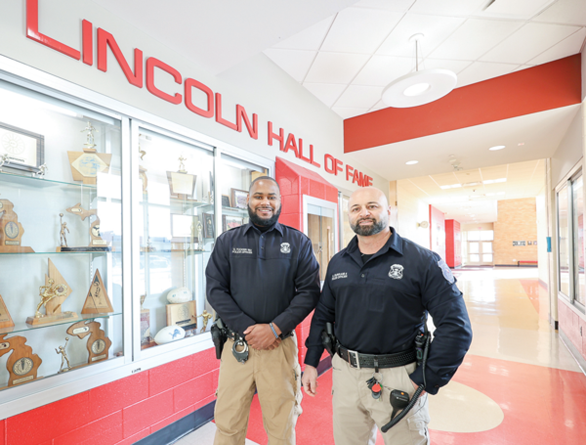  Officers DeAndre Tucker, left, and Adnan Durrani, of the Warren Police Department, both Lincoln High School graduates, are now policing their alma mater as the school resource officers. 
