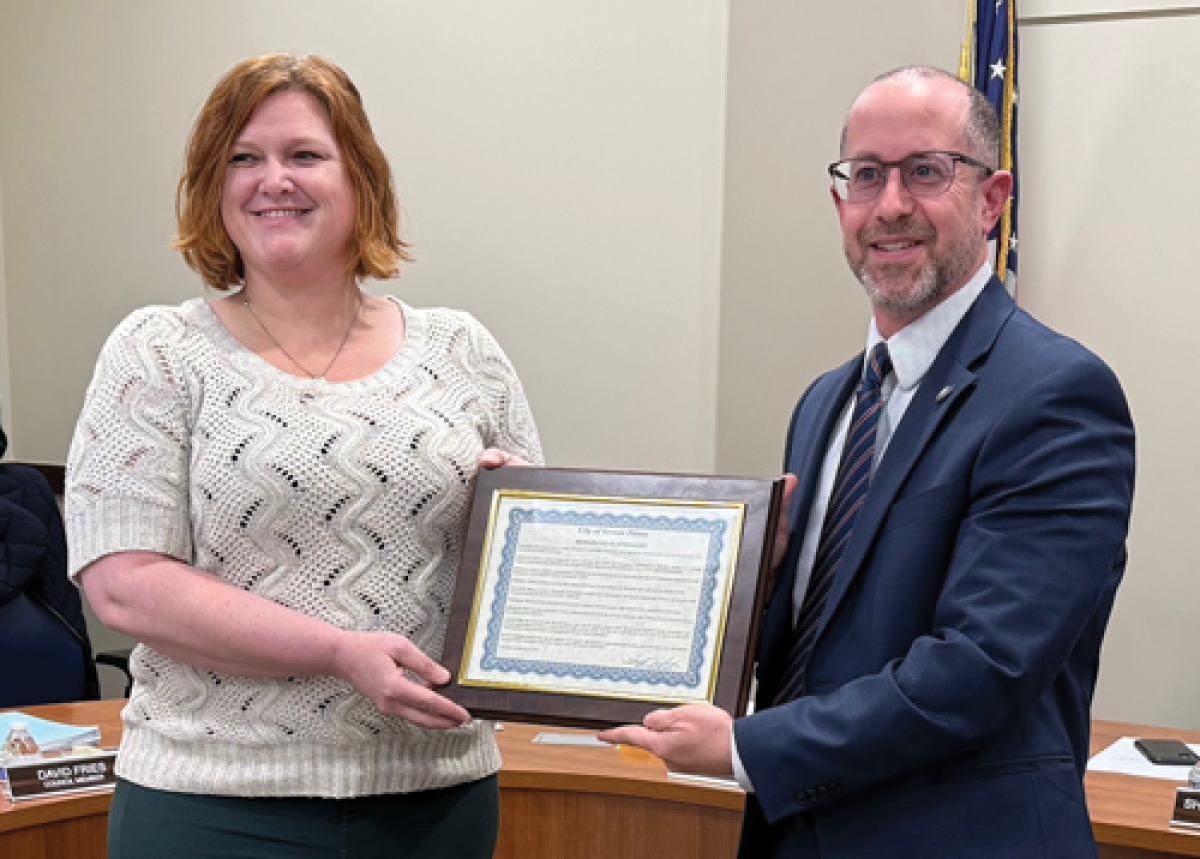  Former Grosse Pointe City Parks and Recreation Coordinator Rebecca Jenzen is presented with a proclamation in her honor March 17 by City Manager Joseph Valentine. 