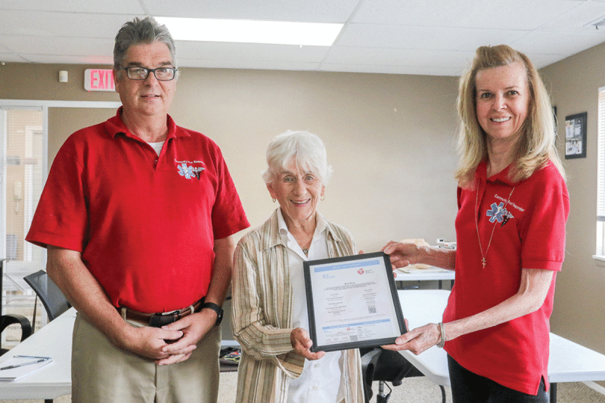  Fran Benz, center, receives her CPR certification from Community First Responder owner Rich Brujitske and the instructor for the class that Benz completed, Rose Black. 