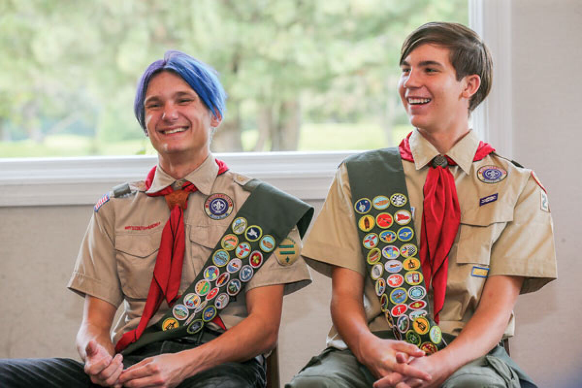  Kalvin Hasenauer, left, and Carter Schury, right, listen as their parents and scoutmaster give comments during their Eagle Scout Court of Honor on Sept. 18 in Macomb Township. 
