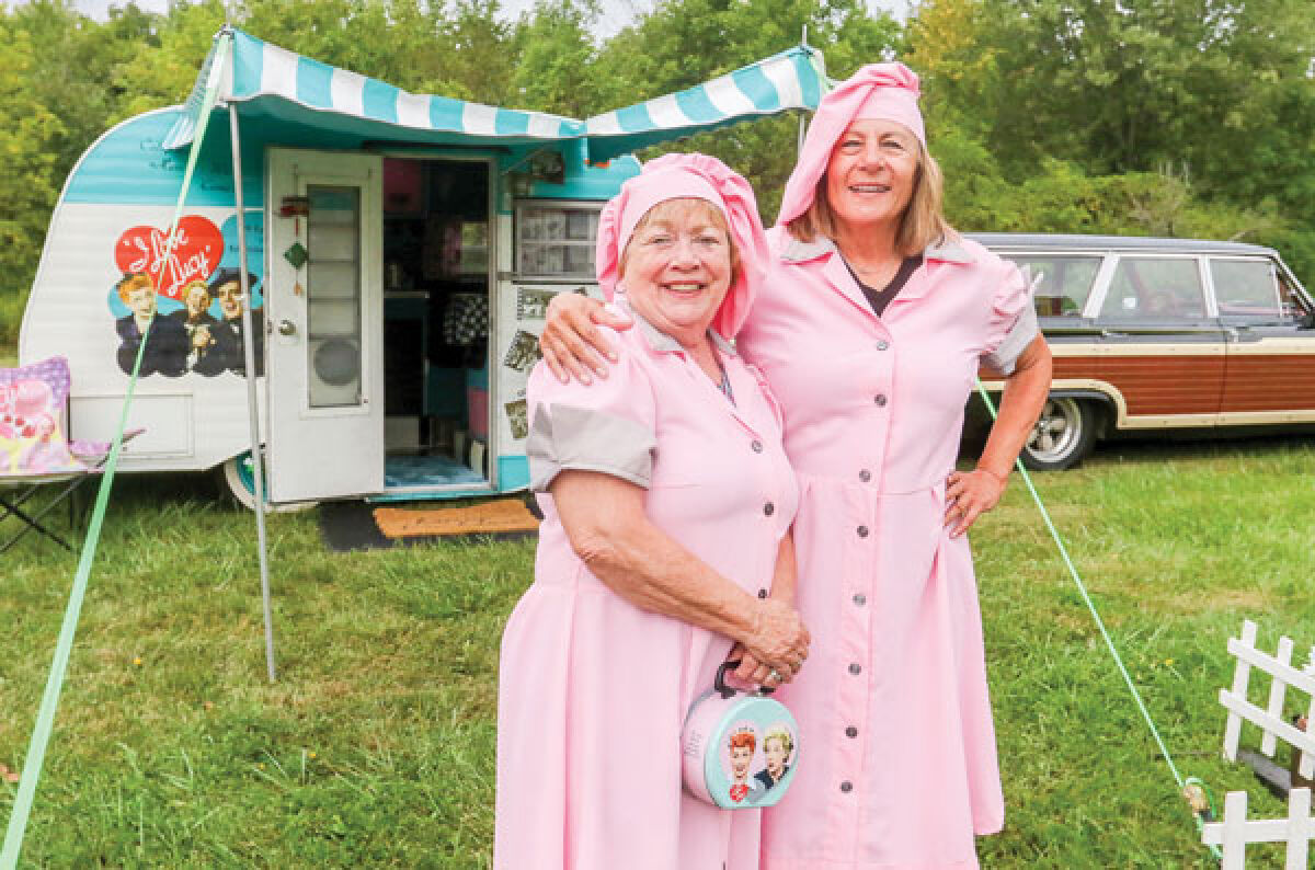  Elaine Vermeersch, left, and Victoria Mobley stand outside the “Lucy Trailer” in their  “I Love Lucy” get-ups. Vermeersch has decorated the vintage Scotty trailer to pay tribute to the 1950s television sitcom. 